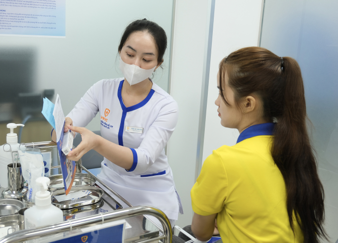 Người tiêm được điều dưỡng VNVC giới thiệu về loại vaccine, hạn sử dụng trước khi tiêm. Ảnh: Mộc Miên