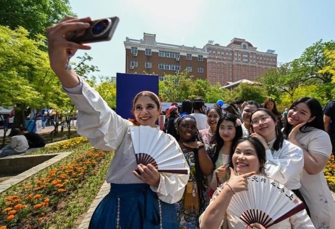 Sinh viên chụp ảnh selfie trong Lễ hội Văn hóa Quốc tế lần thứ 8 của Đại học Ngoại ngữ Thiên Tân, Trung Quốc, hôm 20/4. Ảnh: Xinhua