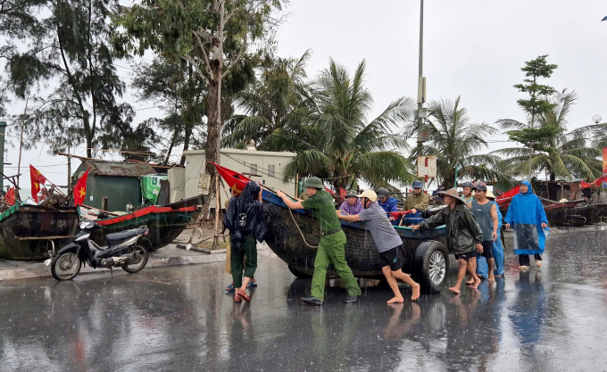 Công an, dân quân tự vệ, đoàn thanh niên hỗ trợ ngư dân đưa thuyền bè lên đường Hồ Xuân Hương (Thanh Hoá). Ảnh: Lê Hoàng