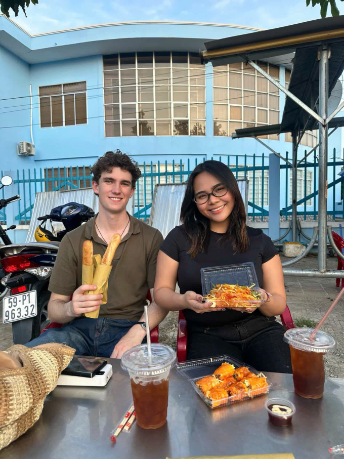 Zane Hanson (trái), 21 tuổi, người New Zealand thích thú ăn đồ ăn vặt ở TP HCM, tháng 7/2025. Ảnh: Nhân vật cung cấp