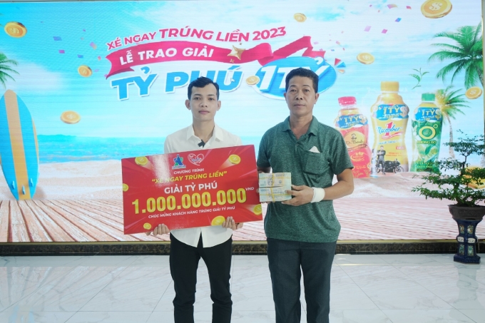 Anh Nguyễn Hoàng Em cùng cha nhận giải thưởng trị giá một tỷ đồng nhờ uống nước tang lực Number 1 và tham gia chương trình khuyến mãi hè năm 2023. Ảnh: Nước tăng lực Number 1