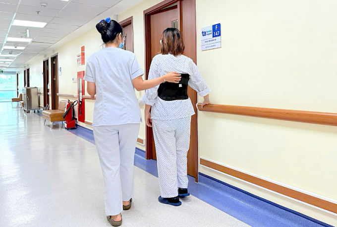Ly tập đi lại dưới sự hướng dẫn, hỗ trợ của kỹ thuật viên. Ảnh: Bệnh viện Đa khoa Tâm Anh