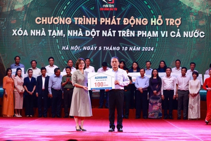 Đại diện Agribank trao tặng 100 tỷ đồng hỗ trợ chương trình xóa nhà tạm, nhà dột nát trên cả nước. Ảnh: Agribank