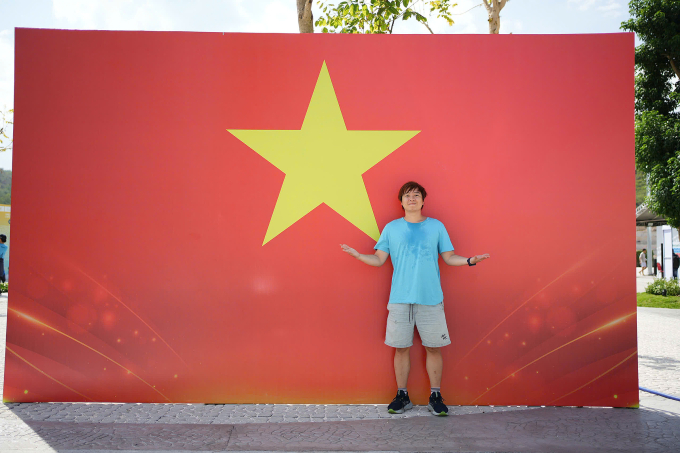 Nhạc sĩ check-in cùng backdrop hình Quốc kỳ của VM Nha Trang 2025. Ảnh: VM