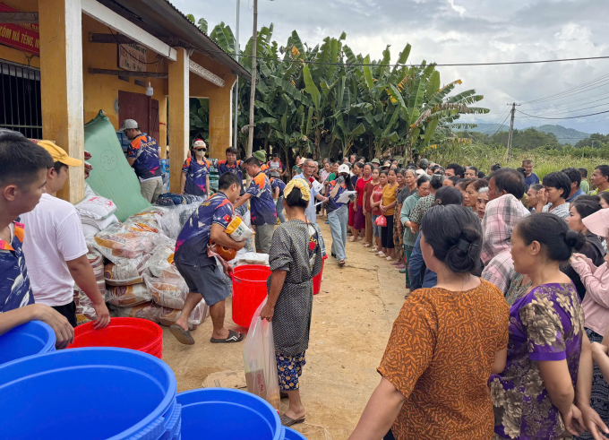 Người dân Hòa An (Cao Bằng) nhận nhu yếu phẩm, chăn ấm mùa đông và thùng nhựa đựng nước sạch từ một nhóm thiện nguyện. Ảnh: Nam Lan