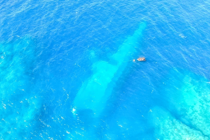 In this photo provided by the New Zealand Defence Force, divers survey the area around HMNZS Manawanui on the southern coast of Upulo, Samoa, after the Manawanui ran aground and sank on Oct. 6, 2024. AP