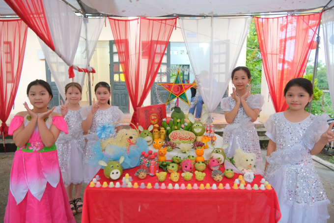 Các em học sinh bên cạnh mâm ngũ quả tự trang trí. Ảnh: Quỳnh Anh