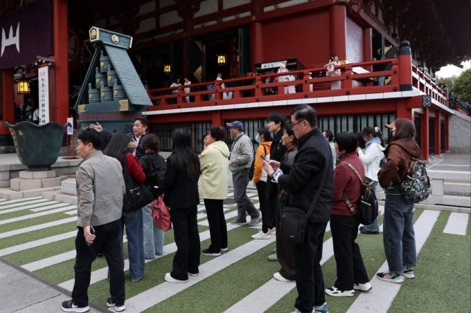 Khách Nhật tập trung lắng nghe hướng dẫn viên du lịch thuyết minh khi tại Nhật Bản. Ảnh: SCMP