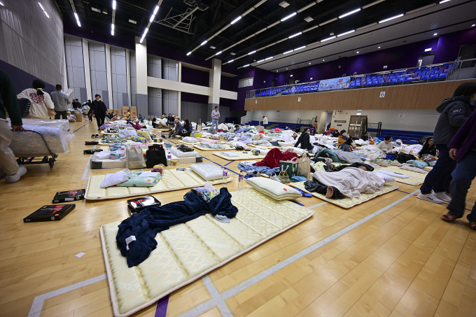 his photo shows an interior view of a temporary shelter near a residential area fire site in Hong Kong, south China, Nov. 27, 2025. Three men have been arrested for suspected manslaughter in a fire that broke out in Wang Fuk Court, a residential area in Tai Po of Hong Kong, on Wednesday afternoon, the Hong Kong Police Force said at a press briefing on Thursday.