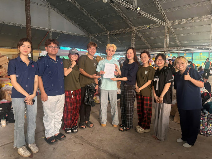 Nhóm sinh viên bàn giao 5 chỉ vàng cho cô Thủy, cán bộ Cung Văn hóa Lao động TP HCM (thứ 4 từ phải qua), chiều 26/11. Ảnh: Anh Khoa